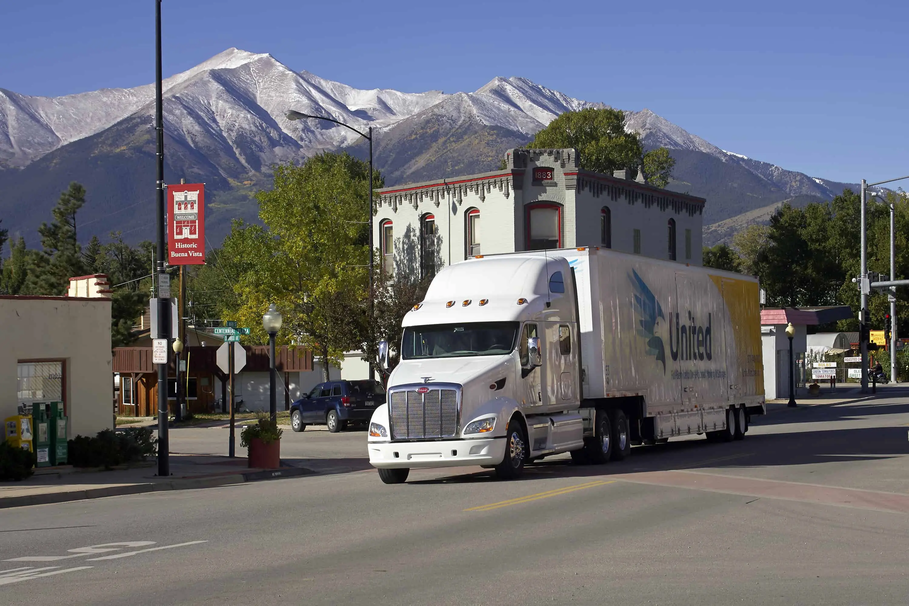 United Van Lines truck driving through a mountain town - United Van Lines®