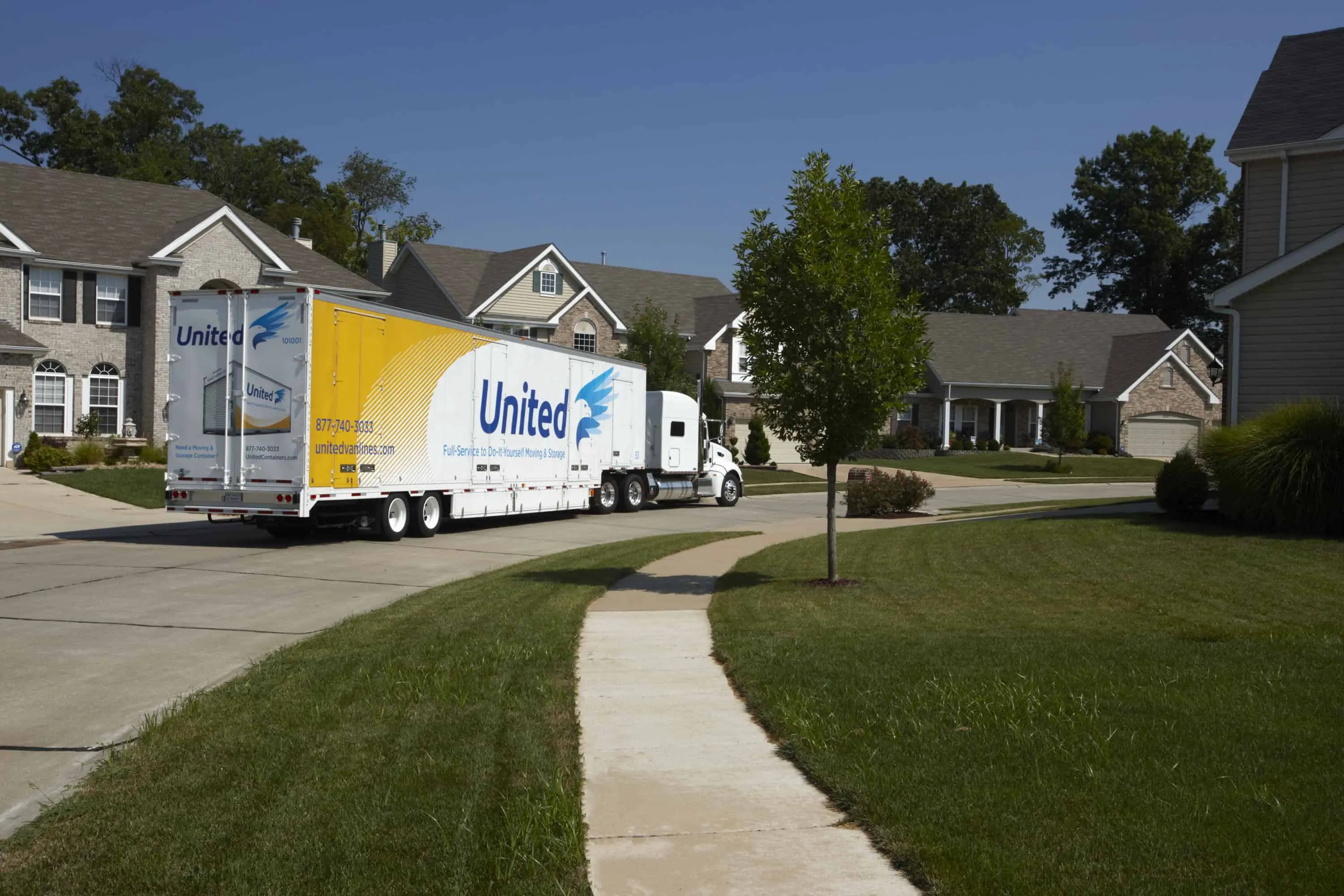 United Van Lines truck driving out of a residential neighborhood - United Van Lines®