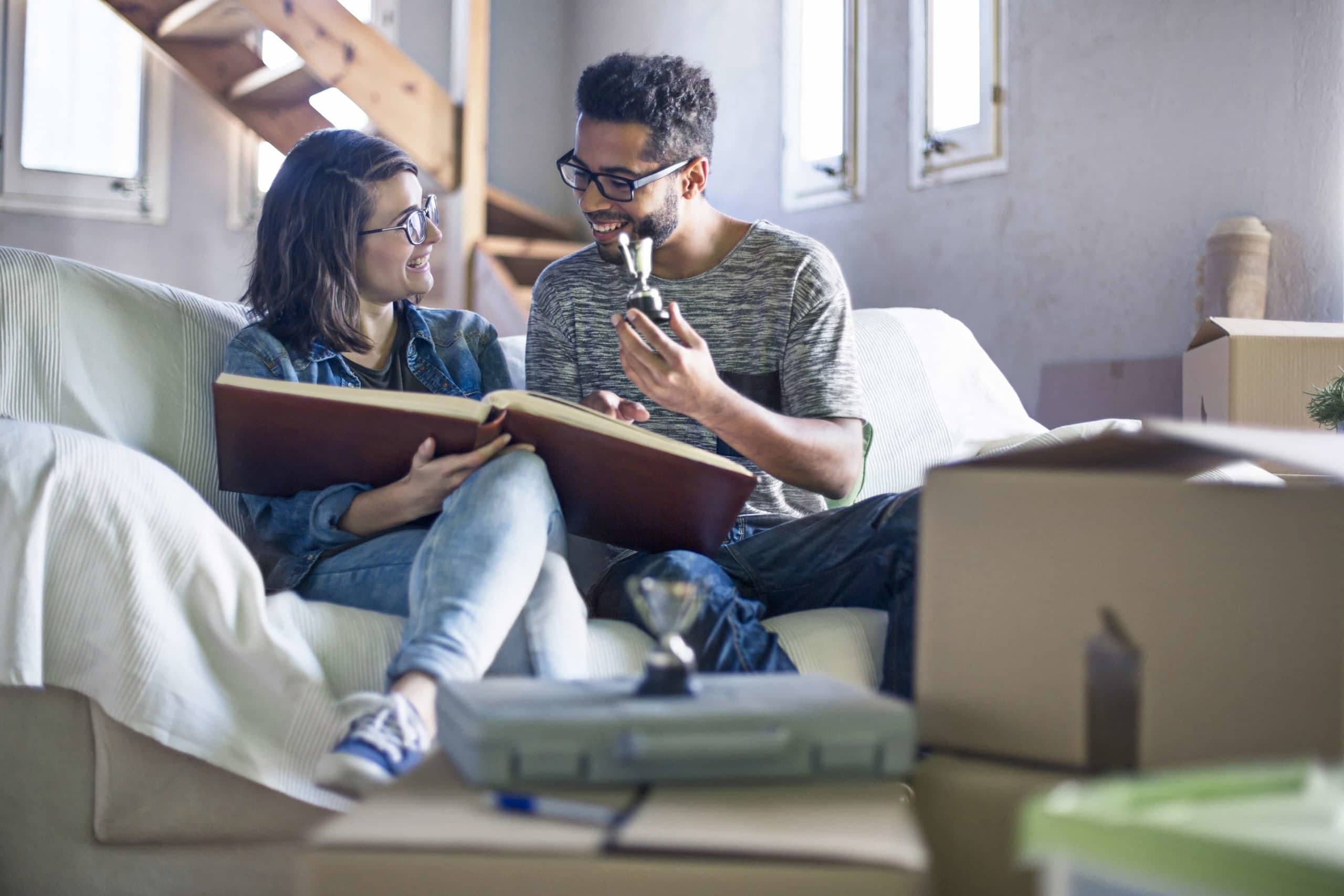 Couple looking at a photo album - Unpacking after moving - United Van Lines