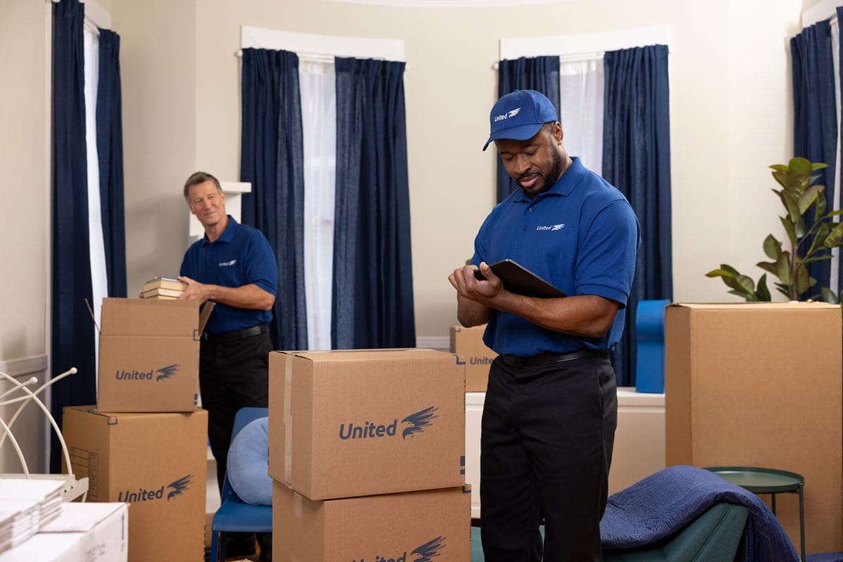 United Van Lines agents packing and reviewing inventory form