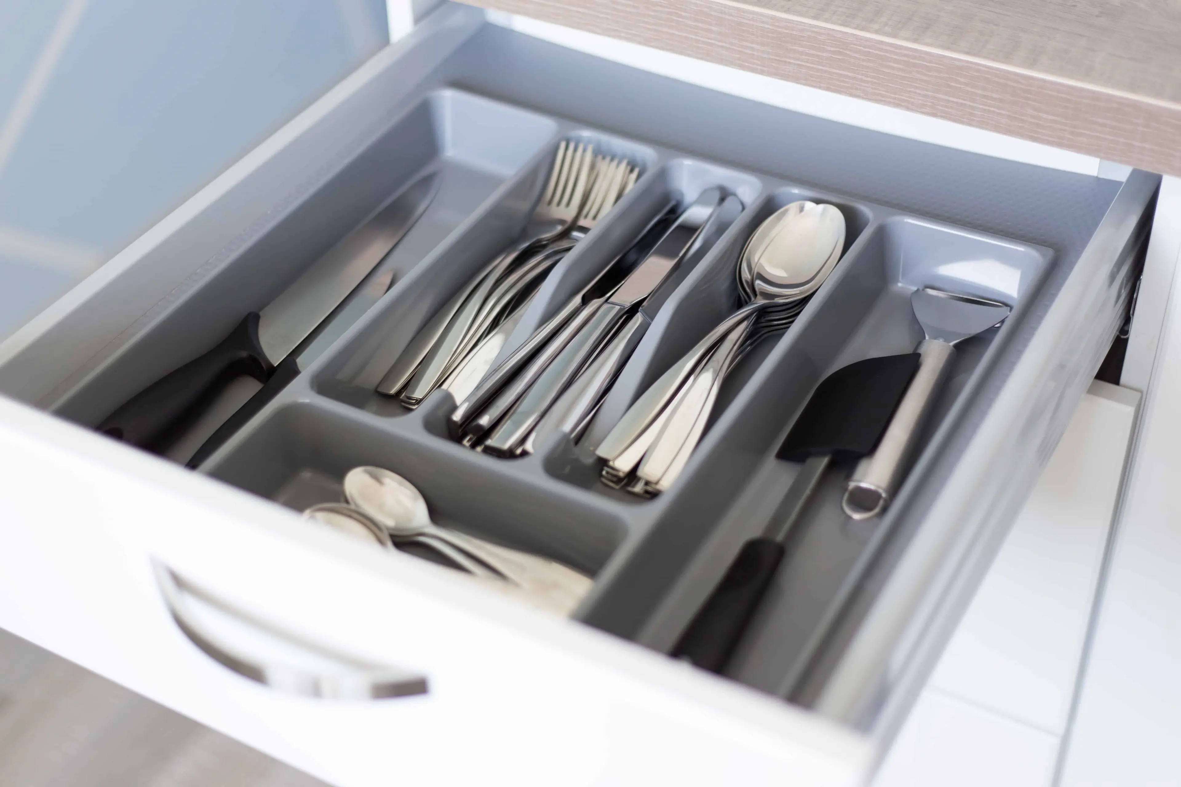How to Pack Silverware for Moving - close up of drawer with cutlery in modern kitchen - United Van Lines