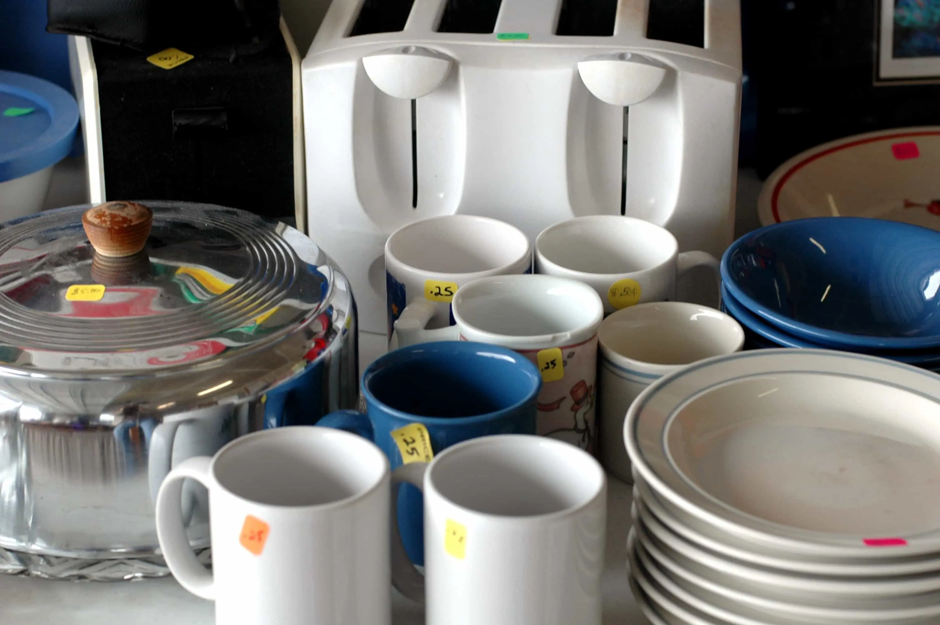 How to Plan a Garage Sale - A group of dishes at a yard sale. - United Van Lines